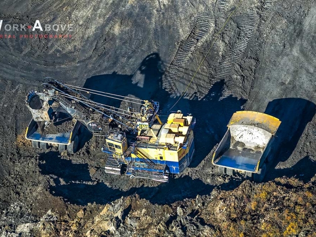Aerial photo of shovel loading bitumen on giant truck in oilsands